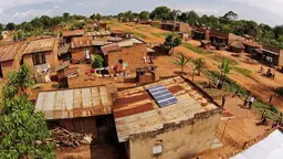 This 500W solar system in a rural village in Uganda powers a home, a public broadcasting system, a barbershop and a video hall (Photo: SolarNow via USAID, Creative Commons via Flickr)