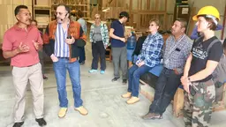 The community owners of a furniture factory pose for a photo