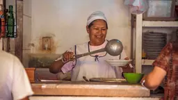 A cook serves up the daily soup at the Achumani market in La Paz (Photo: Mauricio Panoso)