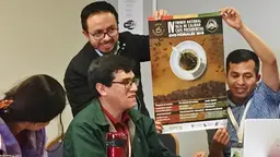 Bolivian family farming organisations show a poster about their award-winning coffee business development activity at the World Rural Forum in Bilbao, Spain (Photo: Duncan Macqueen/IIED)