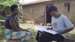 A volunteer conducting an interview outside