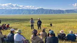 People sitting in a pasture