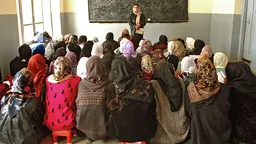 Schoolgirls and a teacher in a classroom