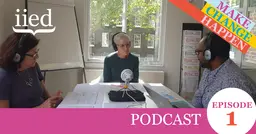 Three people talk into a microphone around the table