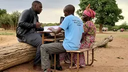 An interview takes place by people seated at a table
