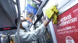A worker cleans a train