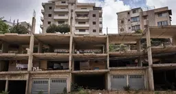 A block of unfinished buildings, open to the elements
