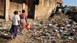 Two women walking in a slum