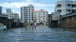 A man walking in a flooded street