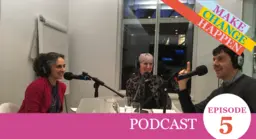 People sit around a desk and talk into microphones