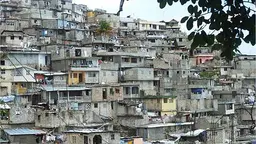 A view from distance of dozens of buildings in close proximity on a hill 