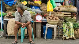 A stallholder in front of a food stall
