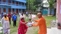A man wearing a face mark hands a bag to a woman also wearing a face mask