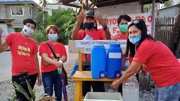 A group of people at a handwashing facility