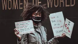 A woman holding signs