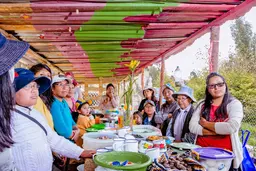 Group of people around a table eating a meal