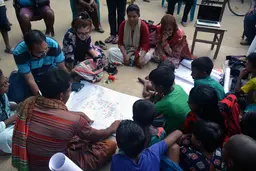 A group of people sitting in a circle 