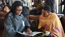 Two women looking at a report