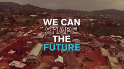Aerial view of poor community. Overtext reads "We can shape the future"