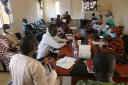 People sitting around a meeting table