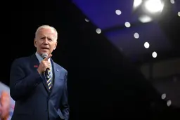 US President Joe Biden speaking with a microphone