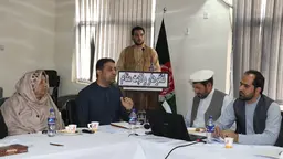 Group of people in discussion seated at a table