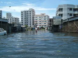 Flooded street with tall buildings in the background