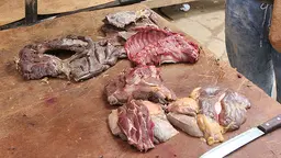 Raw meat and a knife on a table