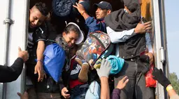 People cram into a vehicle doorway