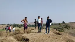 A group of people gather on top of a hill.