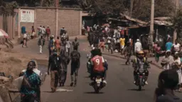 Busy road with people and motorbikes.