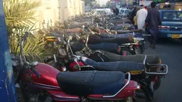 Row of motorbikes parked on the road.