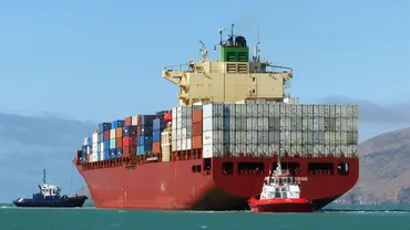 Container ship sailing through Antwerp bridge