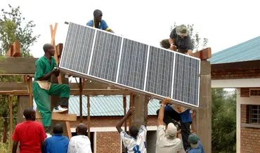 Installing solar panels in Rwanda. Photo: Solar Electric Light Fund (SELF)