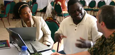Isilda Nhantumbo, Bright Sibale, and Duncan Macqueen exchange ideas at a Forest Governance Learning Group Learning Event in Mozambique. Photo: Leianne Rolington