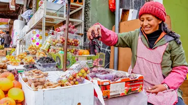 A stallholder measures her produce in a marketplace