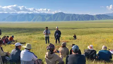 People sitting in a pasture