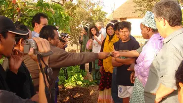 A group of people from different backgrounds greeting each other and taking photographs