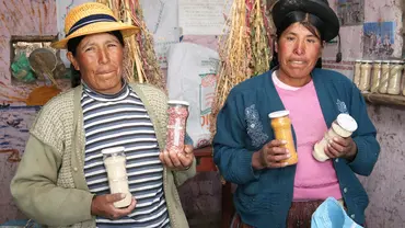 Two women holding jars of quinoa