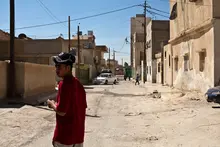Young man on an empty street looking back.