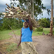 A woman carries firewood / A woman carries firewood home, Kenya. (Photo: Robin Wyatt)