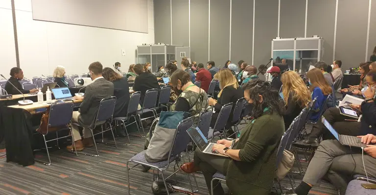 Room full of people sitting down and looking at their laptops