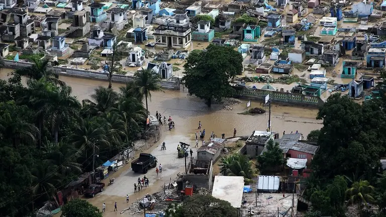 Aerial view of a flooded city with destroyed housing and infrastructure