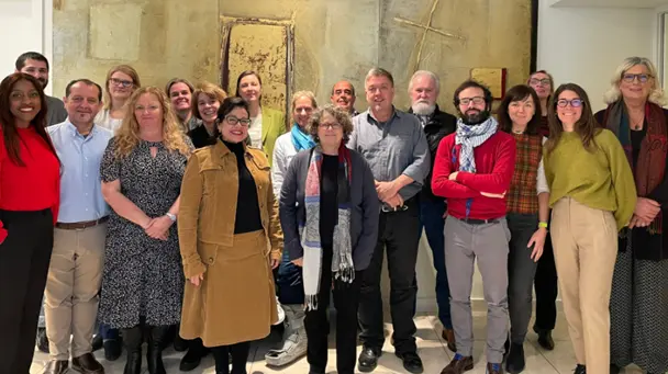 A group of people stand and pose for a group photo