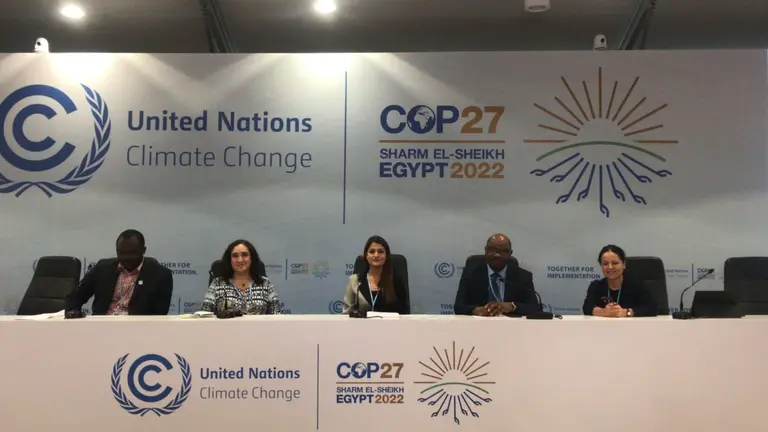 Five people sitting on a long panel table that reads "Unted Nations Climate Change, COP27, Sharm el-Sheikh, Egypt 2022"