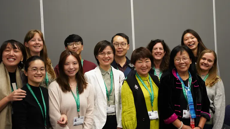 Group of people smiling and posing for a photo