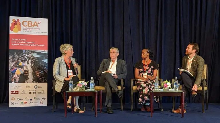 Four people sitting in a panel