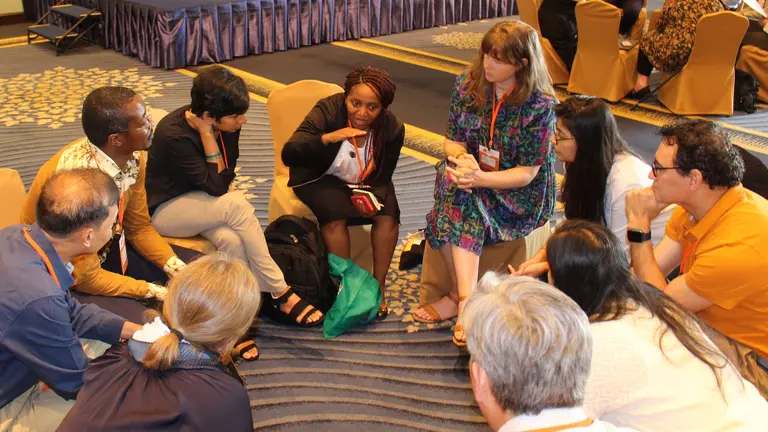 Group of people sitting on the floor in a circle