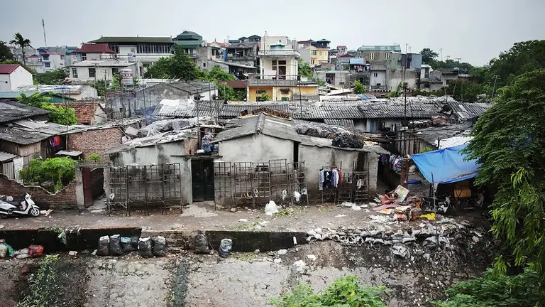 Aerial view of informal housing surrounded by garbage.