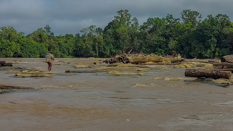 Man walks on river.